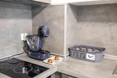 a kitchen counter with a blender and a basket of food at Cozy 1BR in Heart of Oborishte with Private Parking in Sofia