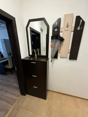 a room with a dresser and a mirror on a wall at Апартамент Клисура in Plovdiv