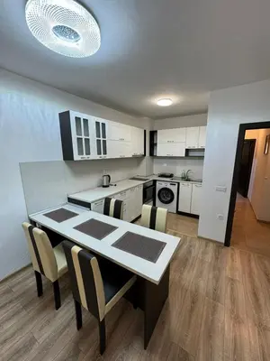 a kitchen and dining room with a table and chairs at Апартамент Клисура in Plovdiv