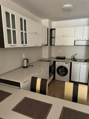 a kitchen with white cabinets and a stove top oven at Апартамент Клисура in Plovdiv