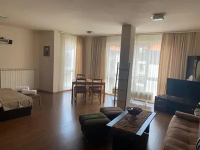 a living room with a couch and a table at Bansko Royal Towers APARTMENT 738 in Bansko