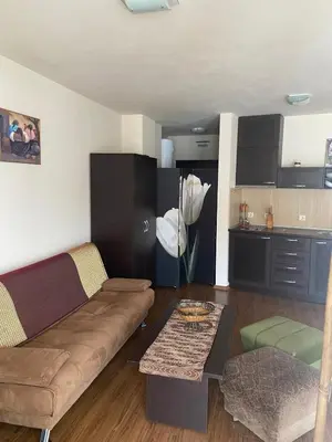 a living room with a couch and a table at Bansko Royal Towers APARTMENT 738 in Bansko