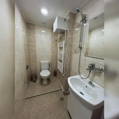 a bathroom with a toilet and a sink at Къща Цвети in Dobrinishte