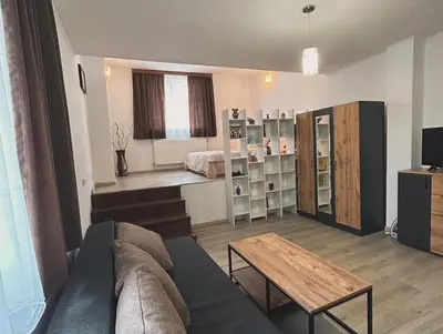 a living room with a couch and a table at Къща Цвети in Dobrinishte