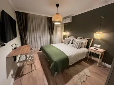 a bedroom with a bed and a desk in it at Elements Stylish Central 1BDR w High Speed WiFi and Work Space in Sofia