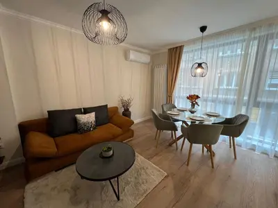 a living room with a couch and a table at Elements Stylish Central 1BDR w High Speed WiFi and Work Space in Sofia