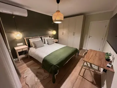 a bedroom with a bed and a table in it at Elements Stylish Central 1BDR w High Speed WiFi and Work Space in Sofia