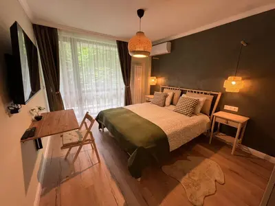 a bedroom with a bed and a table and a window at Elements Stylish Central 1BDR w High Speed WiFi and Work Space in Sofia