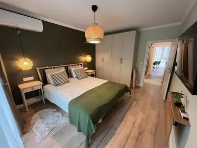 a bedroom with a bed and a green wall at Elements Stylish Central 1BDR w High Speed WiFi and Work Space in Sofia