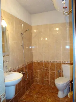 a bathroom with a toilet and a sink at Дамянова Къща in Dobrinishte
