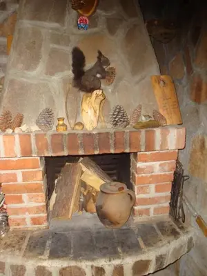 a brick fireplace with a pot on top of it at Дамянова Къща in Dobrinishte