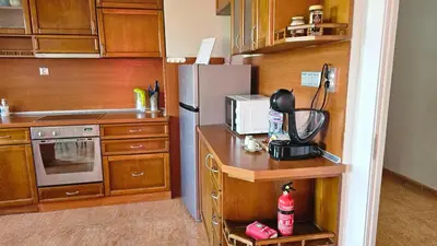 a kitchen with a refrigerator and a microwave at Business Park Retreat: 1BR with Mountain View in Sofia