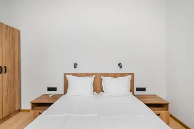 a bedroom with a large white bed with white pillows at Cozy Flats Near Alexander Nevski Cathedral by Flat Mаnager in Sofia