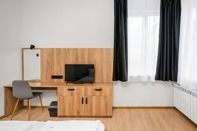 a bedroom with a desk with a television on a desk at Cozy Flats Near Alexander Nevski Cathedral by Flat Mаnager in Sofia