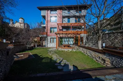 a house on a hill with a yard in front of it at Къща за гости Приказка in Klisura