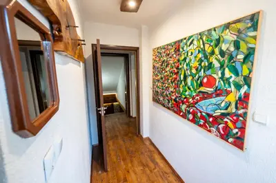 a painting hanging on a wall in a hallway at Къща за гости Приказка in Klisura