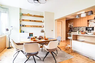 a kitchen and dining room with a table and chairs at Luxury And Spacious Apartment at the Hearth of the City in Sofia