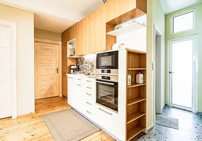 a kitchen with white cabinets and a microwave at Luxury And Spacious Apartment at the Hearth of the City in Sofia