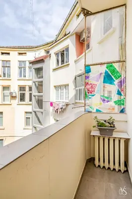 a balcony with a window with a painting at Luxury And Spacious Apartment at the Hearth of the City in Sofia