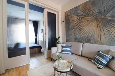 a living room with a couch and a table at NEW The Blue Heart Of Sofia Center in Sofia