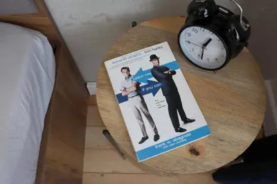 a book sitting on a table next to a clock at NEW The Blue Heart Of Sofia Center in Sofia
