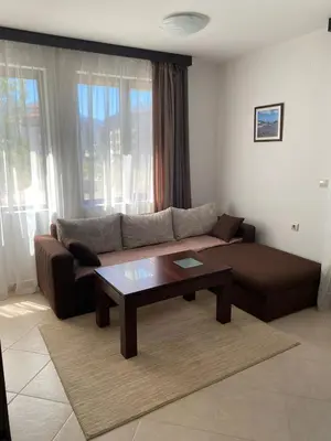 a living room with a couch and a coffee table at Hill Top Studio Apartments in Bansko