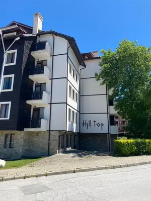 a building with writing on the side of it at Hill Top Studio Apartments in Bansko