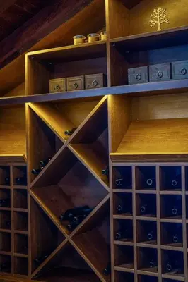 a wooden cabinet filled with wine bottles and wine glasses at The Chalet 2 Bedrooms Paradise in Bansko