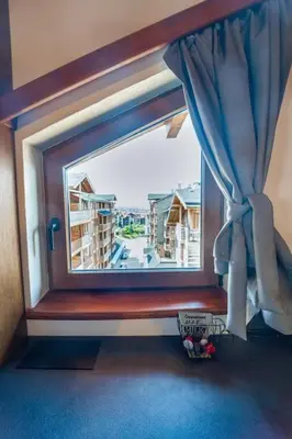 a window with a view of a building at The Chalet 2 Bedrooms Paradise in Bansko