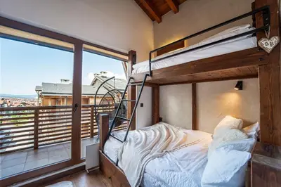 a bedroom with a bunk bed and a balcony at The Chalet 2 Bedrooms Paradise in Bansko