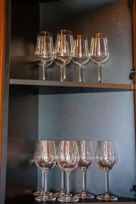 a group of wine glasses sitting on a shelf at The Chalet 2 Bedrooms Paradise in Bansko