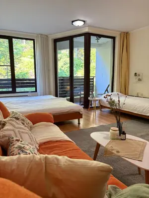 a living room with two beds and a couch at Николай Желев-Първи ЕООД in Pamporovo