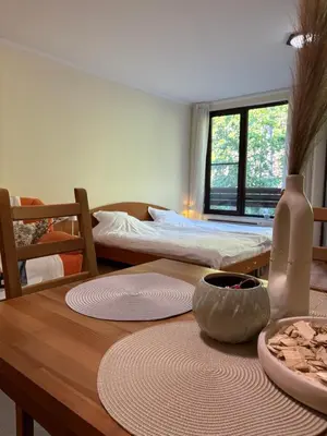 a dining room with a table and a bed at Николай Желев-Първи ЕООД in Pamporovo