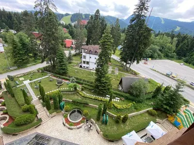 an aerial view of a garden with a building at Студио в Хотел Айсберг in Borovets