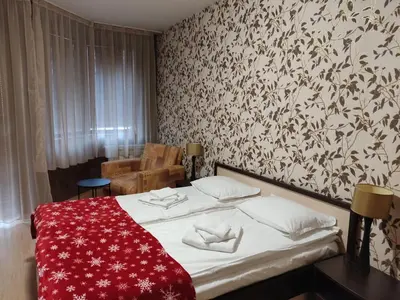 a bedroom with a bed with a red blanket at Студио в Хотел Айсберг in Borovets