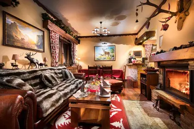 a living room with a couch and a fireplace at Mountain Villa Borovets in Borovets