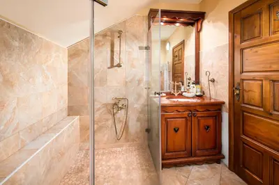 a bathroom with a shower and a tub and a sink at Mountain Villa Borovets in Borovets