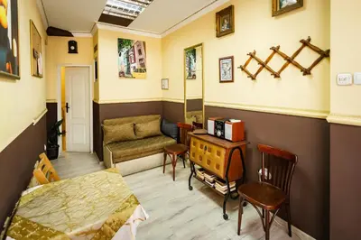 a living room with a bed and a table at Residence Art Guest House in Plovdiv