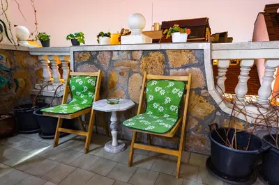 two chairs and a table on a balcony at Residence Art Guest House in Plovdiv