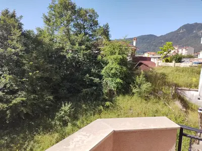 a view of a hill with trees and houses at New & Stylish Apartment Axel with Mountain Views in Smolyan