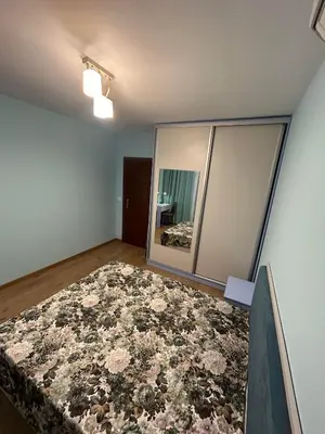 a room with a large rug on the floor and a mirror at New & Stylish Apartment Axel with Mountain Views in Smolyan