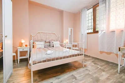 a bedroom with a bed and a desk and a window at Central 47 in Sofia