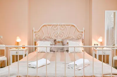 a bedroom with a white bed with white pillows at Central 47 in Sofia
