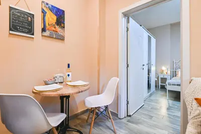 a small table and chairs in a room with a door at Central 47 in Sofia