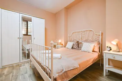 a bedroom with a bed and a crib in it at Central 47 in Sofia