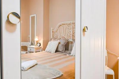 a bedroom with a bed and a mirror at Central 47 in Sofia
