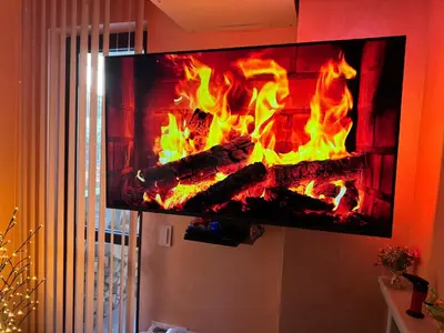 a tv hanging on a wall with a fireplace at 2-bedroom, 2-bathroom with fireplace and garden at Winslow Infinity in Bansko