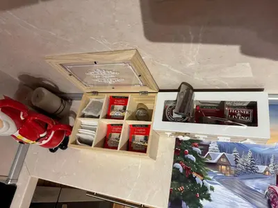 a box with christmas items in it next to a christmas tree at 2-bedroom, 2-bathroom with fireplace and garden at Winslow Infinity in Bansko