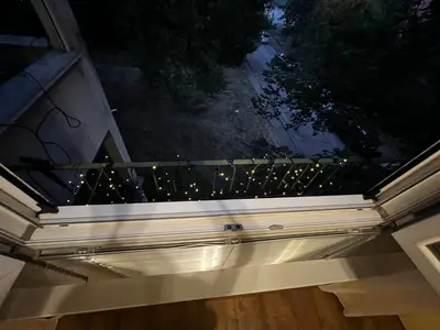 a balcony of a house with lights on it at Cute and Cozy Flat in Sofia