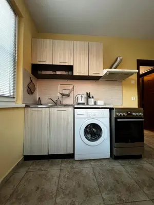 a kitchen with a white washing machine in it at Cute and Cozy Flat in Sofia